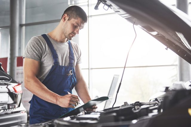 Portrait Of A Mechanic At Work In His Garage - Car Service, Repa